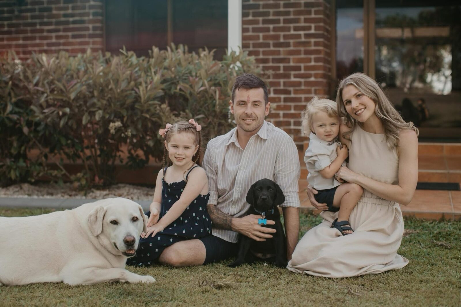 Ryan with his family and dogs outside their home in Bundaberg